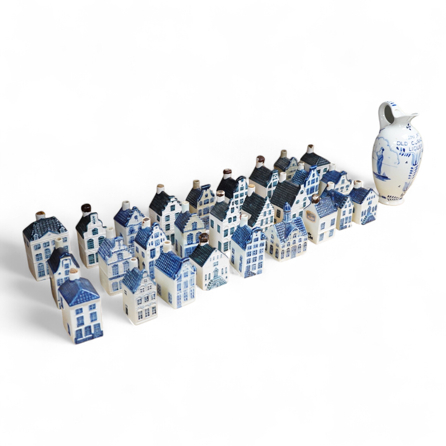 A collection of twenty seven KLM Delft blue miniature houses presented to Business class passengers together with a Delft jug - 20.5cm high